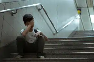 boy on stairs with cell phone