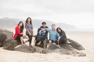 family on beach with disabled child. 