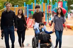 Family with disabled child outside together on a walk
