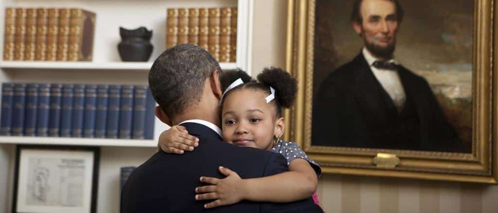 Girl hugging President Obama